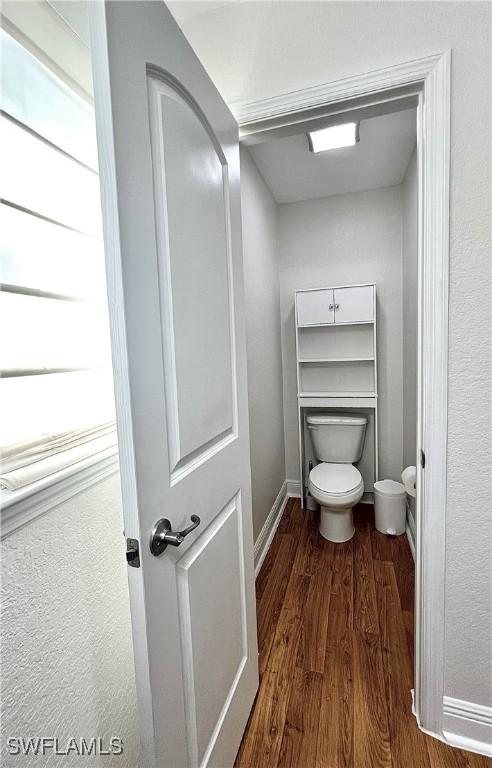 bathroom featuring hardwood / wood-style floors and toilet