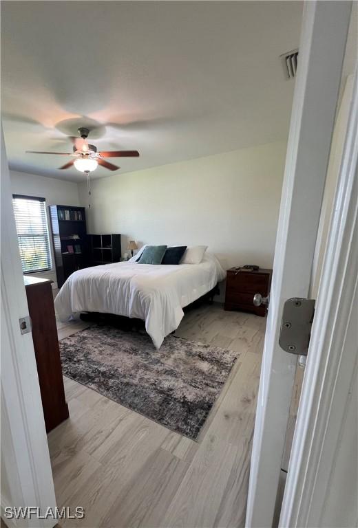 bedroom featuring light hardwood / wood-style flooring and ceiling fan