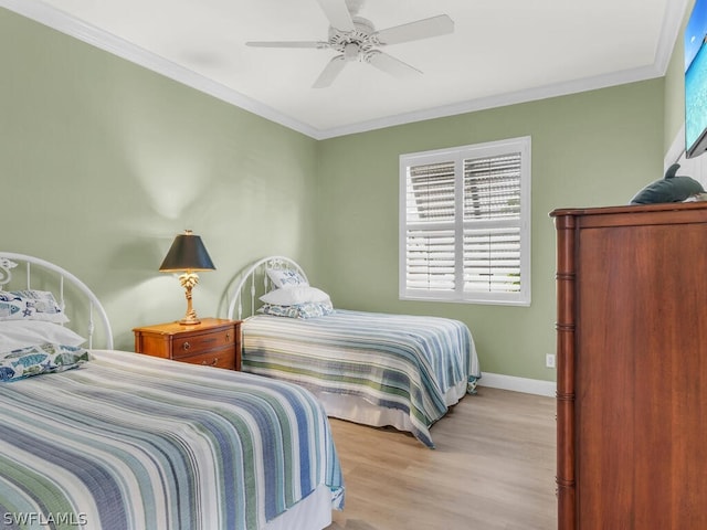 bedroom featuring light wood-type flooring, ceiling fan, and crown molding