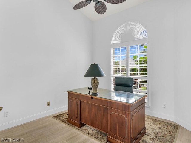 office space with ceiling fan, light hardwood / wood-style floors, and lofted ceiling