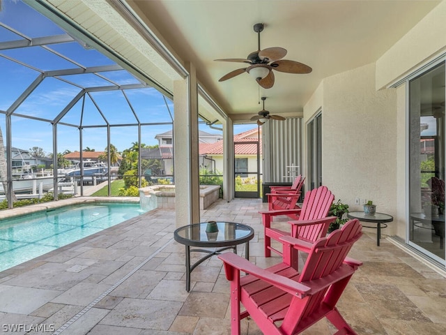 view of patio with a swimming pool with hot tub, ceiling fan, and a lanai