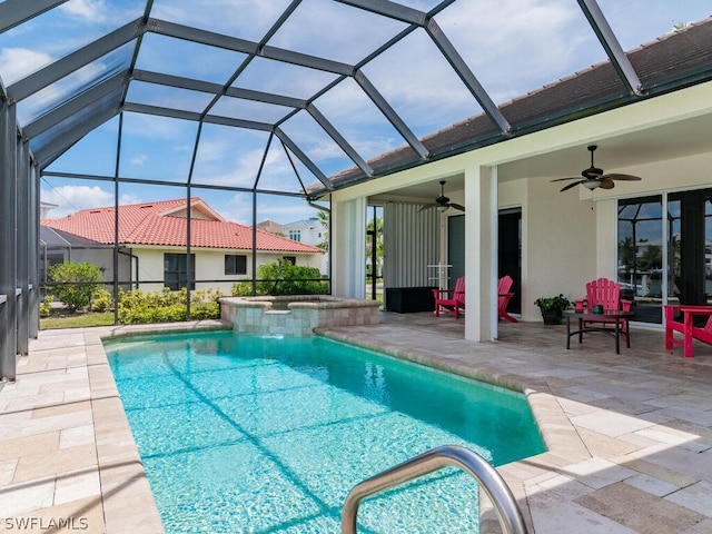 view of swimming pool with a lanai, ceiling fan, and a patio area