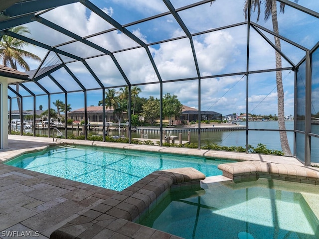 view of pool with a lanai and a water view