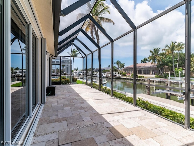 unfurnished sunroom with a water view and lofted ceiling