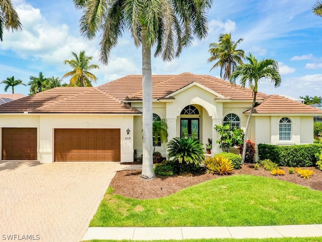 mediterranean / spanish-style house featuring french doors and a garage