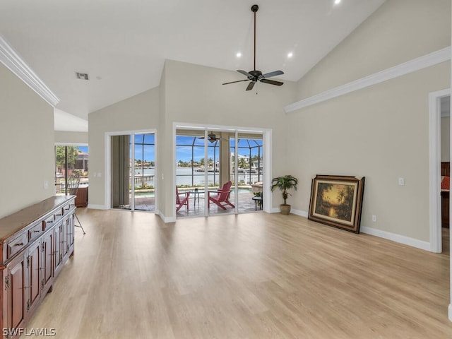 living room with light hardwood / wood-style floors, high vaulted ceiling, ceiling fan, and ornamental molding