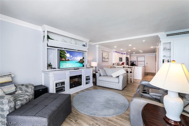 living room featuring ornamental molding and hardwood / wood-style floors