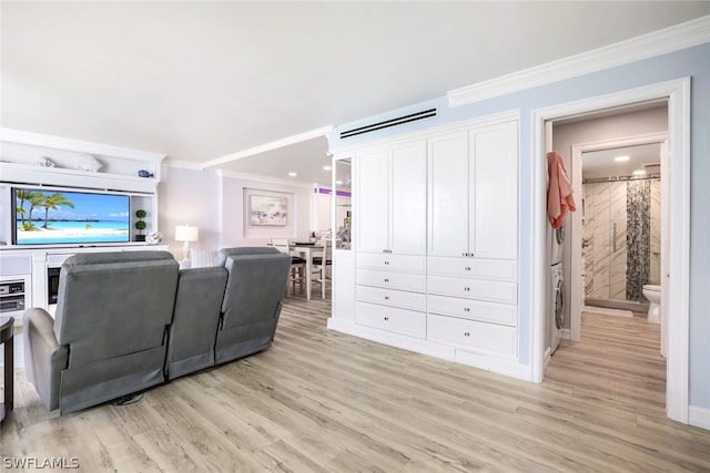 living room with ornamental molding and light hardwood / wood-style flooring