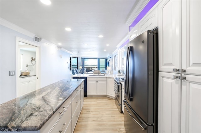 kitchen with white cabinetry, sink, light wood-type flooring, and stainless steel appliances