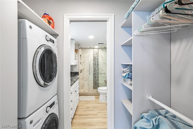 washroom featuring stacked washer / drying machine and light wood-type flooring