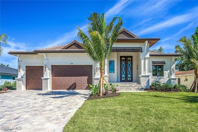 view of front of house with a garage and a front yard