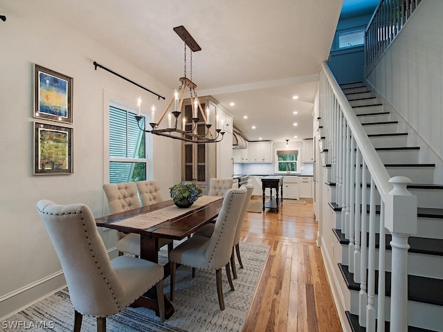 dining space featuring a chandelier and light wood-type flooring