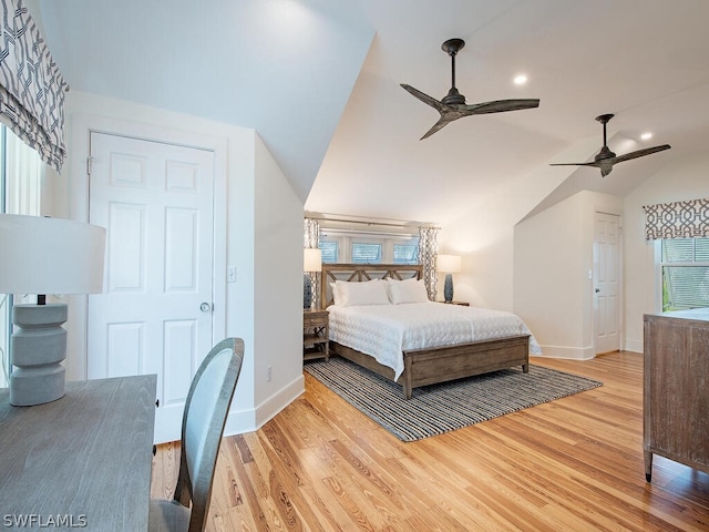 bedroom featuring ceiling fan, vaulted ceiling, and light wood-type flooring