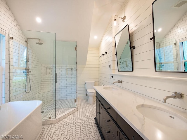 full bathroom featuring lofted ceiling, tile floors, shower with separate bathtub, toilet, and dual bowl vanity