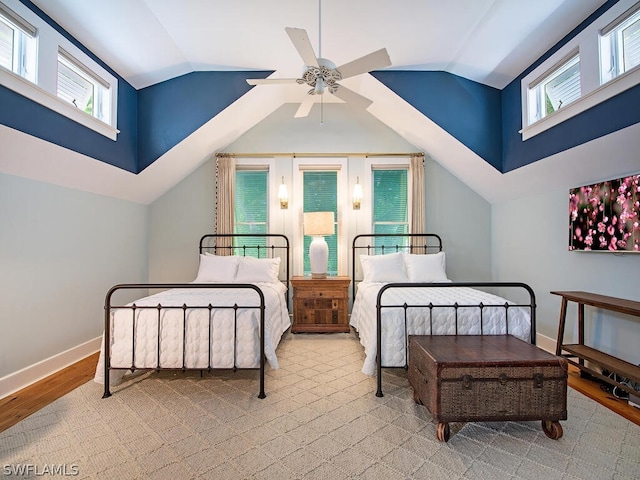 bedroom with light hardwood / wood-style floors, ceiling fan, and vaulted ceiling