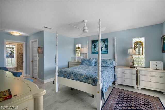 tiled bedroom featuring ceiling fan and multiple windows