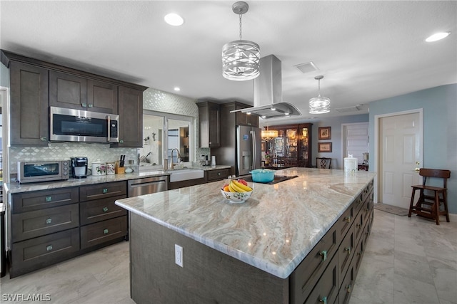 kitchen featuring extractor fan, light stone countertops, sink, stainless steel appliances, and a center island