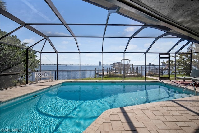 view of swimming pool featuring glass enclosure and a patio area