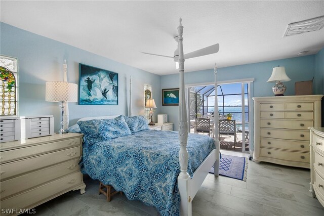 tiled bedroom with a water view, access to exterior, and ceiling fan