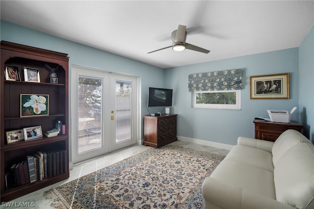 tiled office space featuring ceiling fan and french doors