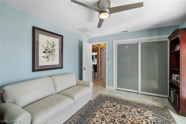 tiled living room featuring ceiling fan