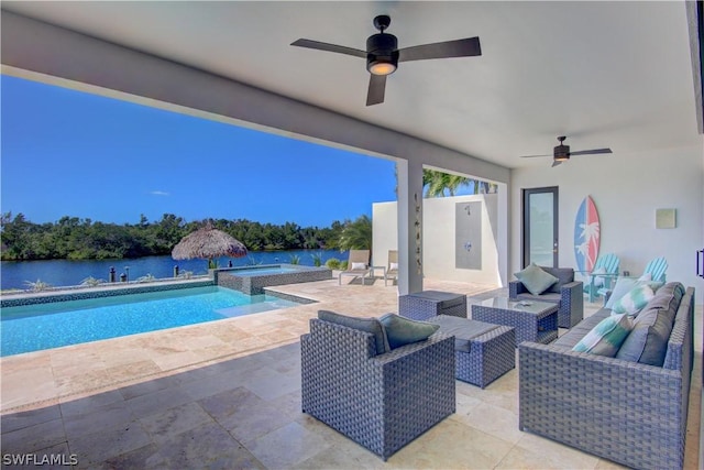 view of patio / terrace featuring a pool with hot tub, outdoor lounge area, and a water view