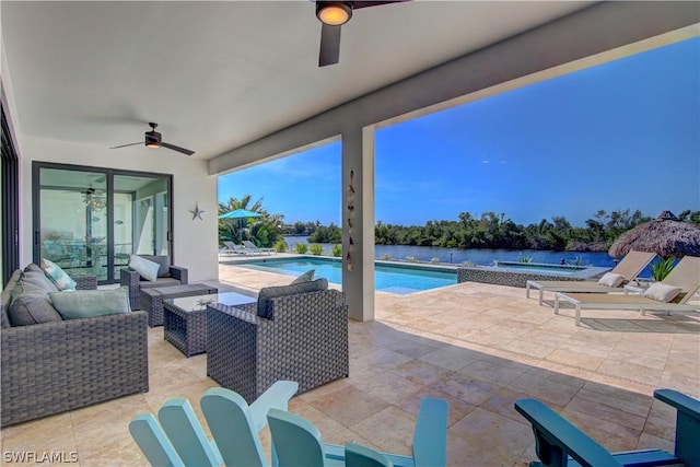 view of patio featuring ceiling fan, a pool with hot tub, a water view, and an outdoor living space