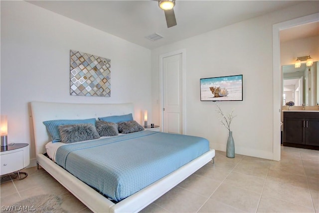 tiled bedroom with ensuite bath and ceiling fan