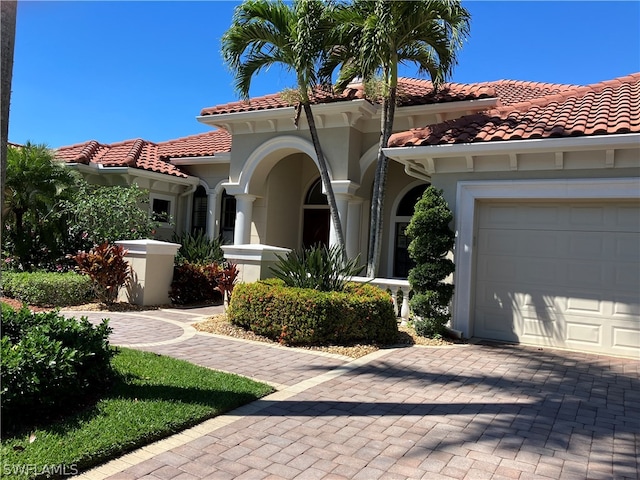 mediterranean / spanish house with a garage