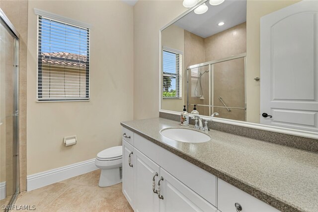 bathroom featuring toilet, tile floors, and large vanity