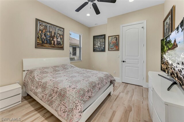 bedroom with ceiling fan and light wood-type flooring