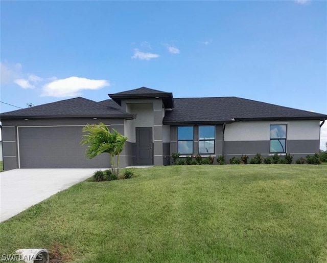 prairie-style home with a front yard and a garage