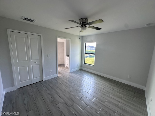 unfurnished bedroom with a closet, light hardwood / wood-style floors, and ceiling fan