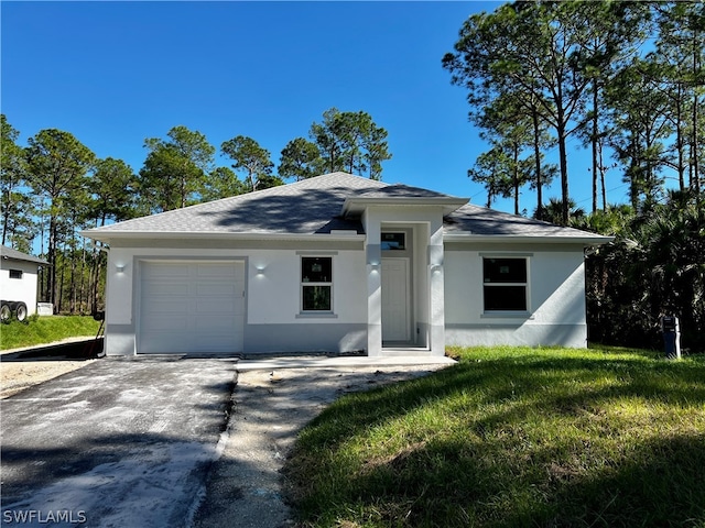 view of front facade featuring a front yard and a garage