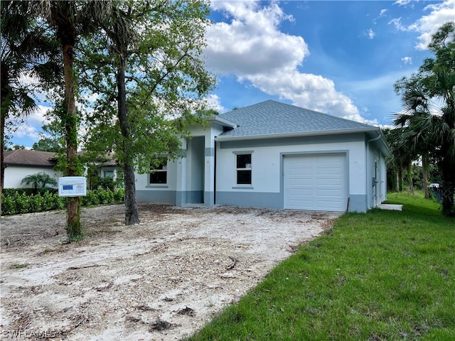 ranch-style house with a front yard and a garage