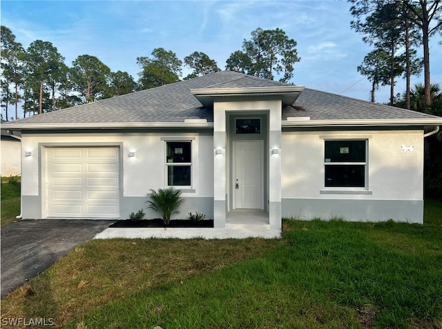 view of front of house featuring a front yard and a garage