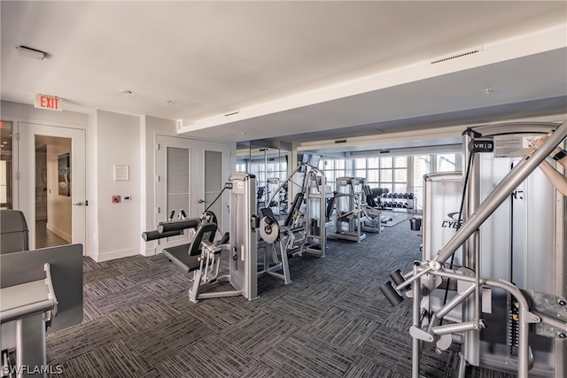 workout area featuring dark colored carpet