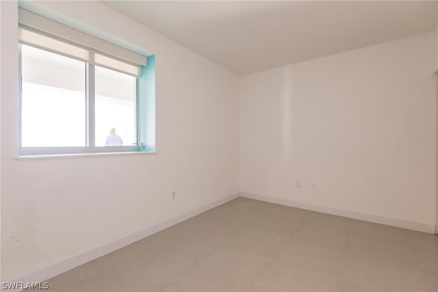 unfurnished room with light tile flooring