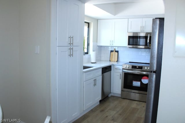 kitchen featuring white cabinetry, decorative backsplash, and stainless steel appliances