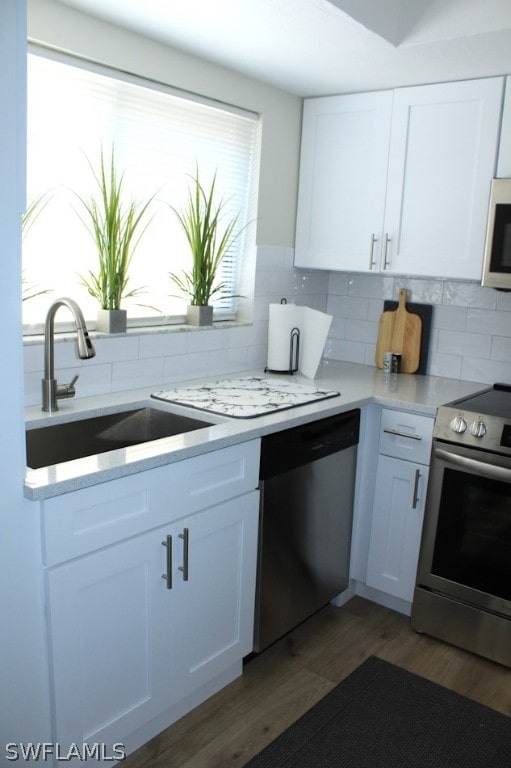 kitchen featuring sink, white cabinets, and appliances with stainless steel finishes