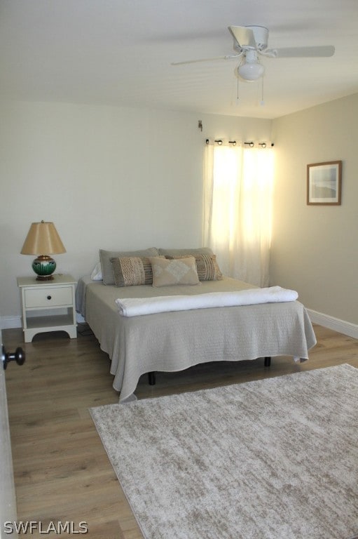 bedroom with hardwood / wood-style flooring and ceiling fan