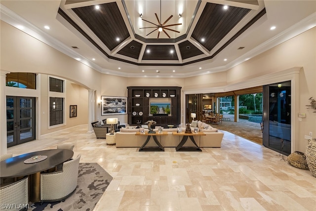 interior space featuring coffered ceiling, a notable chandelier, crown molding, and a towering ceiling