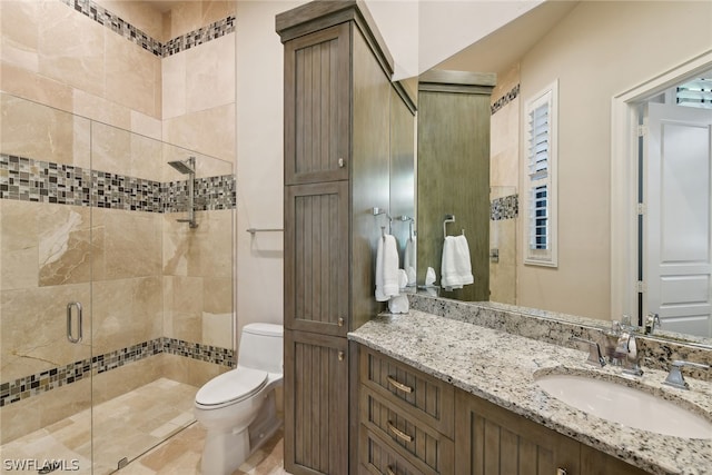 bathroom featuring walk in shower, toilet, and vanity