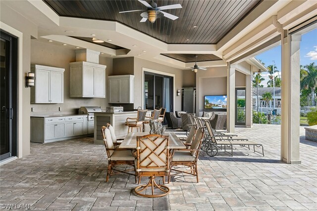 view of terrace featuring a grill and ceiling fan