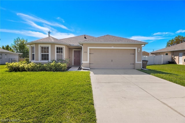 ranch-style house featuring a garage and a front lawn