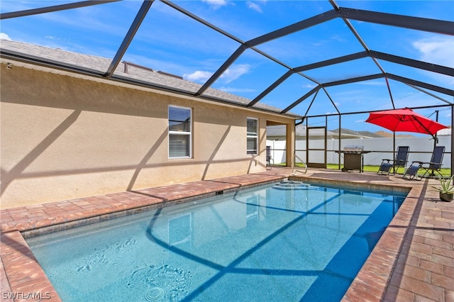 view of pool featuring a patio and glass enclosure