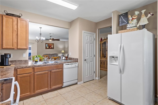 kitchen featuring light tile floors, sink, white appliances, ceiling fan with notable chandelier, and decorative light fixtures