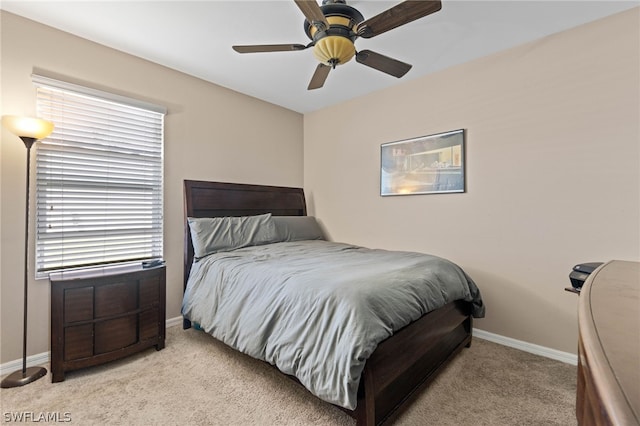 carpeted bedroom with ceiling fan and multiple windows