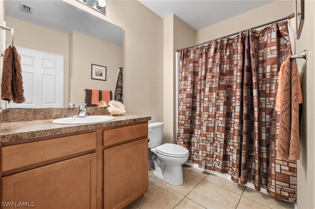 bathroom featuring large vanity, tile floors, and toilet