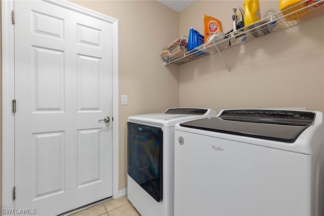 clothes washing area featuring independent washer and dryer and light tile floors